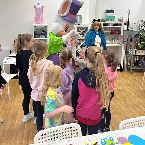 Alice in wonderland characters doing a meet and great with some of the children